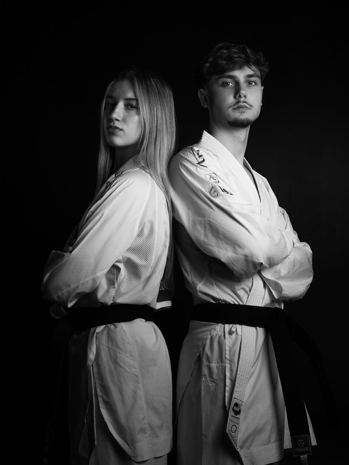 Black and white portrait of Ashley Kakiay and Sebastiaan van Teeffelen back to back